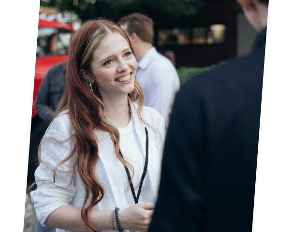 Charles IT employee, Carrie, smiling in conversation at Open House event