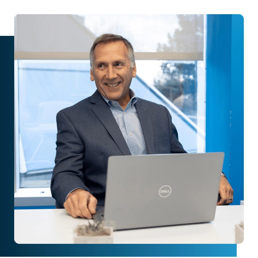 Professional man smiling while working on a computer in a secure office environment