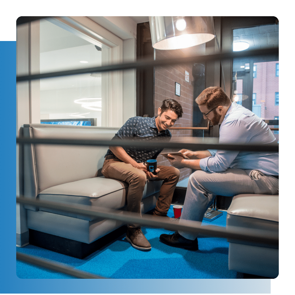 Two IT technicians discussing solutions for industrial equipment and machining operations