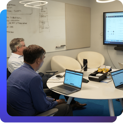 Charles IT team members reviewing systems and discussing IT strategy in a conference room.